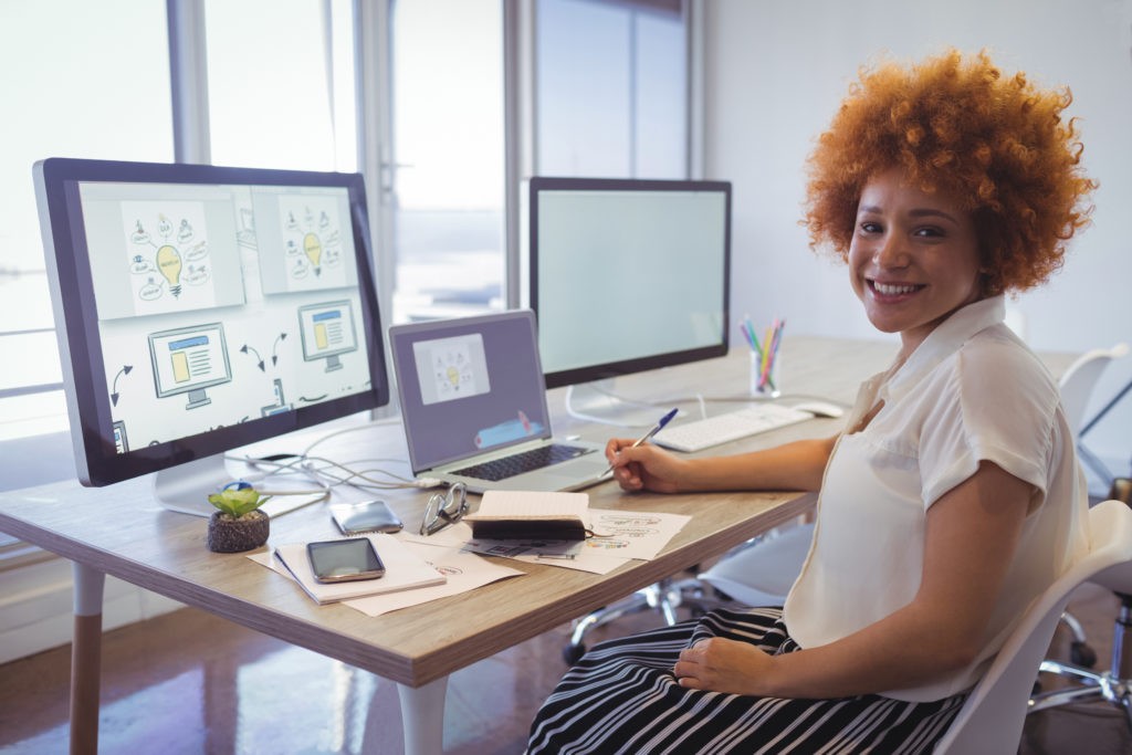 Portrait Of Confident Businesswoman Working In Creative Office